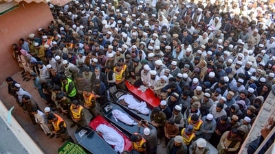 Mourners pray during the funeral ceremony of suicide blast victims, a day after the attack in Bannu. (AFP) Mourners pray during the funeral ceremony of suicide blast victims, a day after the attack in Bannu. (AFP)