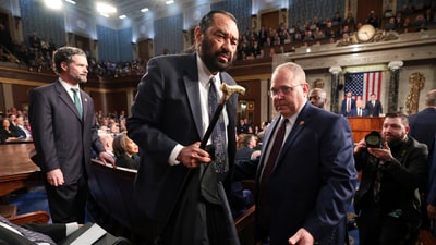 Al Green is removed from the chamber as President Donald Trump addresses a joint session of Congress at the Capitol in Washington. (AP)