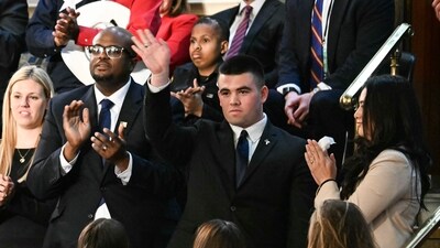 Jason Hartley (C) stands after US President Donald Trump announced that Hartley has been admitted to the US Military Academy West Point during Trump's address to a joint session of Congress in the House Chamber of the US Capitol in Washington, DC. (AFP) Jason Hartley (C) stands after US President Donald Trump announced that Hartley has been admitted to the US Military Academy West Point during Trump's address to a joint session of Congress in the House Chamber of the US Capitol in Washington, DC. (AFP)