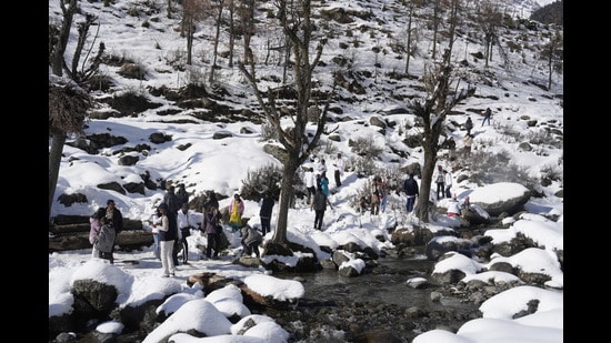 Tourists enjoy after fresh snowfall at Pahalgam in Anantnag district of south Kashmir on Wednesday. (PTI)