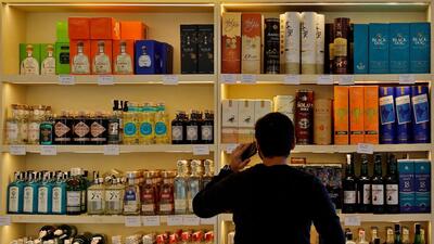 A customer looks at liquor bottles for purchase at a liquor store in NCR. (REUTERS) A customer looks at liquor bottles for purchase at a liquor store in NCR. (REUTERS)