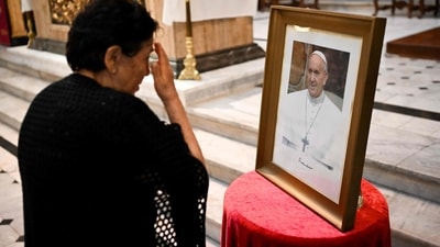 A woman crosses herself in front of a picture of Pope Francis during the celebration of Ash Wednesday at the Basilica San Jose de Flores in Buenos Aires on March 5, 2025. The Basilica de San Jose de Flores was the church where Pope Francis was inspired to consecrate his life to God and the Catholic Church. Pope Francis's condition was stable on Wednesday as he neared three weeks in the hospital battling pneumonia, a Vatican source said, with celebrations for the Lent religious season starting without him. (Photo by LUIS ROBAYO / AFP) (AFP) A woman crosses herself in front of a picture of Pope Francis during the celebration of Ash Wednesday at the Basilica San Jose de Flores in Buenos Aires on March 5, 2025. The Basilica de San Jose de Flores was the church where Pope Francis was inspired to consecrate his life to God and the Catholic Church. Pope Francis's condition was stable on Wednesday as he neared three weeks in the hospital battling pneumonia, a Vatican source said, with celebrations for the Lent religious season starting without him. (Photo by LUIS ROBAYO / AFP) (AFP)