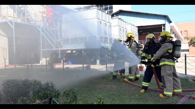 Firefighters in action during the mock drill at Verka Milk plant in Ludhiana on Thursday. (HT Photo) Firefighters in action during the mock drill at Verka Milk plant in Ludhiana on Thursday. (HT Photo)
