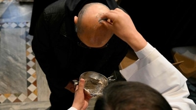A priest sprinkles the head of a clergyman with ashes during a holy mass at the Church of Saint Sabina in Rome during the celebration of Ash Wednesday as Pope francis is still hospitalized with pneumonia, on March 5, 2025. Pope Francis's condition was stable on March 5, 2025 as he neared three weeks in hospital battling pneumonia, a Vatican source said, with celebrations for the Lent religious season starting without him. (Photo by Alberto PIZZOLI / AFP) (AFP) A priest sprinkles the head of a clergyman with ashes during a holy mass at the Church of Saint Sabina in Rome during the celebration of Ash Wednesday as Pope francis is still hospitalized with pneumonia, on March 5, 2025. Pope Francis's condition was stable on March 5, 2025 as he neared three weeks in hospital battling pneumonia, a Vatican source said, with celebrations for the Lent religious season starting without him. (Photo by Alberto PIZZOLI / AFP) (AFP)