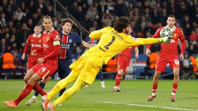 Liverpool goalkeeper Alisson (C) dives to punch the ball during their Champions League match against PSG. (AFP) Liverpool goalkeeper Alisson (C) dives to punch the ball during their Champions League match against PSG. (AFP)