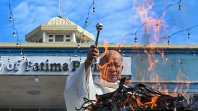 A priest leads the burning of old palm fronds at a church in Las Pinas, Metro Manila on March 4, 2025. The ashes from the burned branches will be used during Ash Wednesday rites which marks the start of lent on March 5. (Photo by Jam STA ROSA / AFP) (AFP) A priest leads the burning of old palm fronds at a church in Las Pinas, Metro Manila on March 4, 2025. The ashes from the burned branches will be used during Ash Wednesday rites which marks the start of lent on March 5. (Photo by Jam STA ROSA / AFP) (AFP)