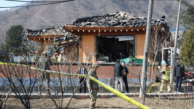South Korea army soldiers stand guard near a bomb accident site where a South Korean fighter jet accidentally dropped bombs on a civilian area during training. (AP) South Korea army soldiers stand guard near a bomb accident site where a South Korean fighter jet accidentally dropped bombs on a civilian area during training. (AP)