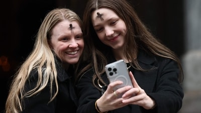 NEW YORK, NEW YORK - MARCH 05: People take selfies after receiving ashes on the forehead on Ash Wednesday at St. Patrick's Cathedral on March 05, 2025 in New York City. Ash Wednesday is the start of Lent, Christianity's 40-day season of prayer, fasting and giving in preparation to honor the resurrection of Jesus Christ on Easter Sunday. The cross which is placed on a worshiper's forehead by a priest indicates that a person belongs to Jesus Christ and is grieving and mourning for their sins. Michael M. Santiago/Getty Images/AFP (Photo by Michael M. Santiago / GETTY IMAGES NORTH AMERICA / Getty Images via AFP) (Getty Images via AFP) NEW YORK, NEW YORK - MARCH 05: People take selfies after receiving ashes on the forehead on Ash Wednesday at St. Patrick's Cathedral on March 05, 2025 in New York City. Ash Wednesday is the start of Lent, Christianity's 40-day season of prayer, fasting and giving in preparation to honor the resurrection of Jesus Christ on Easter Sunday. The cross which is placed on a worshiper's forehead by a priest indicates that a person belongs to Jesus Christ and is grieving and mourning for their sins. Michael M. Santiago/Getty Images/AFP (Photo by Michael M. Santiago / GETTY IMAGES NORTH AMERICA / Getty Images via AFP) (Getty Images via AFP)