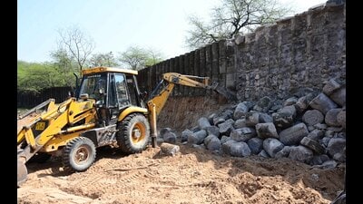 As per the Chandigarh administration, the wall being demolished was originally built to enclose the adjacent forested land and was not part of the garden designed by Nek Chand. (Keshav Singh/HT) As per the Chandigarh administration, the wall being demolished was originally built to enclose the adjacent forested land and was not part of the garden designed by Nek Chand. (Keshav Singh/HT)