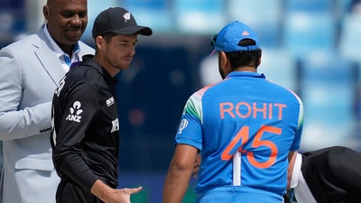 New Zealand's captain Mitch Santner, center, greets India's captain Rohit Sharma after the coin toss (AP) New Zealand's captain Mitch Santner, center, greets India's captain Rohit Sharma after the coin toss (AP)