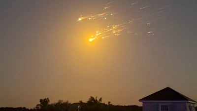A view shows debris streaking through the sky, after SpaceX's Starship spacecraft tumbled and exploded in space, in Big Sampson Kay, Bahamas, March 6, 2025, in this screen grab obtained from social media video. (@_ericloosen_ via REUTERS)