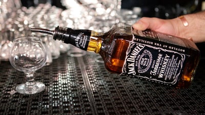 In this March 4, 2011, file photo, a bartender begins to pour a drink from a bottle of Jack Daniels at a bar in San Francisco. ( (Paul Sakuma/AP)