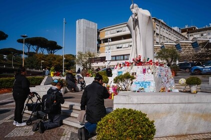 People pray at the statue of John Paul II outside the Gemelli University Hospital where Pope Francis is hospitalized with pneumonia, in Rome on March 7, 2025. (AFP) People pray at the statue of John Paul II outside the Gemelli University Hospital where Pope Francis is hospitalized with pneumonia, in Rome on March 7, 2025. (AFP)