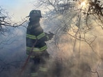 Firefighters respond to a brush fire in Suffolk County in New York's Long Island on Saturday, March 8, 2025. (Steve Pfost/Newsday via AP) Firefighters respond to a brush fire in Suffolk County in New York's Long Island on Saturday, March 8, 2025. (Steve Pfost/Newsday via AP)