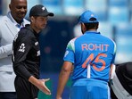 New Zealand's captain Mitch Santner, center, greets India's captain Rohit Sharma New Zealand's captain Mitch Santner, center, greets India's captain Rohit Sharma