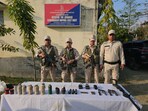 Security personnel display the arms and ammunition surrendered by the public from Churachandpur, Imphal East, and Kangpokpi districts of Manipur. Security personnel display the arms and ammunition surrendered by the public from Churachandpur, Imphal East, and Kangpokpi districts of Manipur.