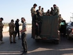 Syrian army personnel gather as they head towards Latakia to join the fight against the fighters linked to Syria's ousted leader Bashar al-Assad, in Aleppo, Syria.
