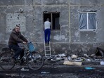 A resident covers a broken window in his apartment damaged by a Russian missile strike as traces of shrapnel are seen on the wall, amid Russia's attack on Ukraine, in the town of Dobropillia, Donetsk region, Ukraine March 8, 2025. 