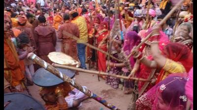 At Barsana, Holi revellers from Nandgaon sang and danced on Holi songs as women dressed as Gopi wielded ‘lathi’ amidst chants of ‘Radha Rani Ki Jai’. (Sourced) At Barsana, Holi revellers from Nandgaon sang and danced on Holi songs as women dressed as Gopi wielded ‘lathi’ amidst chants of ‘Radha Rani Ki Jai’. (Sourced)