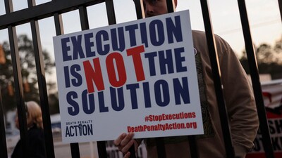 On Friday in South Carolina, protesters holding signs reading “All life is precious” and “Execute justice, not people” assembled outside the prison ahead of Sigmon’s execution. (REUTERS)