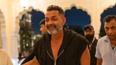 Bobby Deol looking happy and stylish as he arrives at the hotel. 