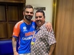 Rajkumar Sharma poses for a photo with Virat Kohli.