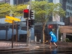 A man walks through the Central Business District (CBD) area of Brisbane on March 8, 2025, as cyclone Alfred crossed the southeast Queensland coast. Cyclone Alfred weakened into a tropical low on March 8 but still threatened to unleash major floods on swollen rivers as it approached the rain and wind-lashed eastern coast of Australia. A man walks through the Central Business District (CBD) area of Brisbane on March 8, 2025, as cyclone Alfred crossed the southeast Queensland coast. Cyclone Alfred weakened into a tropical low on March 8 but still threatened to unleash major floods on swollen rivers as it approached the rain and wind-lashed eastern coast of Australia.