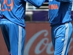 India's Kuldeep Yadav (R) celebrates with teammate Varun Chakravarthy after taking the wicket of New Zealand's Rachin Ravindra during the ICC Champions Trophy one-day international (ODI) final cricket match between India and New Zealand.