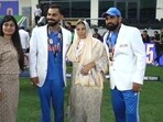 Virat Kohli takes a picture with Mohammed Shami and his family. Virat Kohli takes a picture with Mohammed Shami and his family.