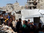 Palestinians gather to receive bread from a bakery, in Khan Younis, in the southern Gaza Strip on Sunday.
