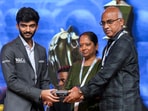 World Chess Champion D Gukesh hands over a memento to his parents J Padmakumari and Rajnikanth. World Chess Champion D Gukesh hands over a memento to his parents J Padmakumari and Rajnikanth.