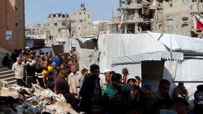 Palestinians gather to receive bread from a bakery, in Khan Younis, in the southern Gaza Strip on Sunday. (Reuters)