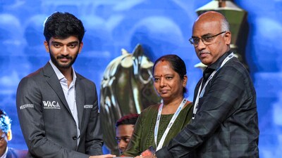 World Chess Champion D Gukesh hands over a memento to his parents J Padmakumari and Rajnikanth. (PTI) World Chess Champion D Gukesh hands over a memento to his parents J Padmakumari and Rajnikanth. (PTI)