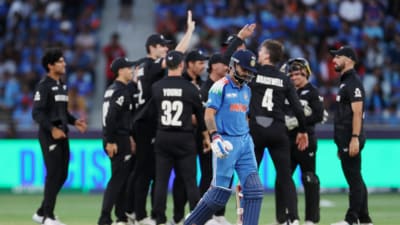 Virat Kohli walks back as New Zealand fielders celebrate Virat Kohli walks back as New Zealand fielders celebrate