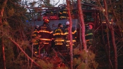 Firefigters assemble around rescue units as they extinguish flames on March 8, 2025 in Westhampton, New York. (Photo by Andrew Theodorakis / GETTY IMAGES NORTH AMERICA / Getty Images via AFP) (Getty Images via AFP) Firefigters assemble around rescue units as they extinguish flames on March 8, 2025 in Westhampton, New York. (Photo by Andrew Theodorakis / GETTY IMAGES NORTH AMERICA / Getty Images via AFP) (Getty Images via AFP)