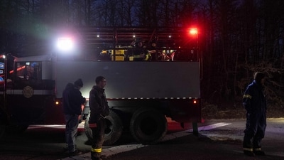 Firemen stand on the road side near Francis S. Gabreski Airport as the rapidly spreading fires are posing a threat to more buildings, such as a chemical factory and an Amazon warehouse. (Photo by David Dee Delgado / GETTY IMAGES NORTH AMERICA / Getty Images via AFP) (Getty Images via AFP) Firemen stand on the road side near Francis S. Gabreski Airport as the rapidly spreading fires are posing a threat to more buildings, such as a chemical factory and an Amazon warehouse. (Photo by David Dee Delgado / GETTY IMAGES NORTH AMERICA / Getty Images via AFP) (Getty Images via AFP)