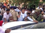 Enforcement Directorate (ED) personnel being stopped as they leave after searching the residence of former Chief Minister and Congress leader Bhupesh Baghel in an ongoing money laundering case, in Durg on Monday.