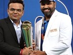 ICC Chairman Jay Shah (L) presents the winning trophy to India's captain Rohit Sharma at the end of the ICC Champions Trophy.