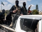 Security forces loyal to the interim Syrian government ride in the back of a vehicle moving along a road in Syria's western city of Latakia on March 9, 2025. Security forces loyal to the interim Syrian government ride in the back of a vehicle moving along a road in Syria's western city of Latakia on March 9, 2025.