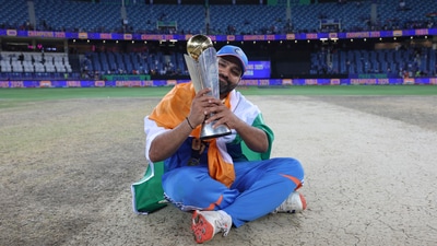 Rohit Sharma poses with the trophy, and appears to be brimming with emotions. (AP)