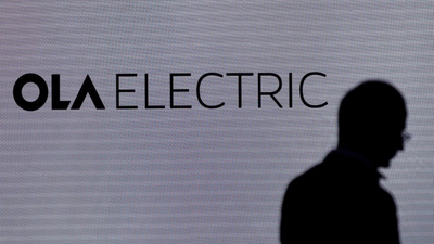 A man walks past the logo of Ola Electric during a press conference ahead of it's IPO launch in Mumbai, India, July 29, 2024. (Francis Mascarenhas/Reuters)