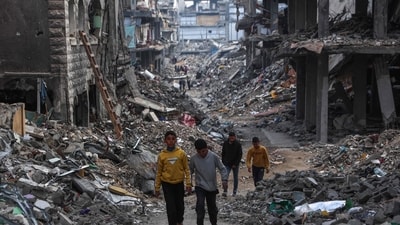 Palestinians walk in a devastated neighbourhood in Beit Lahia in the northern Gaza Strip, ahead of the iftar fast-breaking meal during the Muslim holy month of Ramadan on March 9, 2025. (AFP) Palestinians walk in a devastated neighbourhood in Beit Lahia in the northern Gaza Strip, ahead of the iftar fast-breaking meal during the Muslim holy month of Ramadan on March 9, 2025. (AFP)