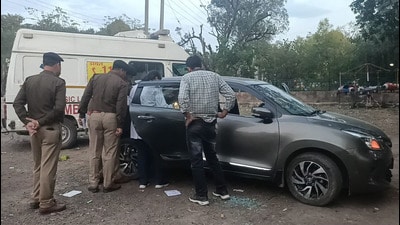 Police inspecting the car in which the Chandigarh police constable was found dead in car at Mata Mansa Devi Complex, Sector 4, Panchkula, on Tuesday evening. (Sant Arora/HT)