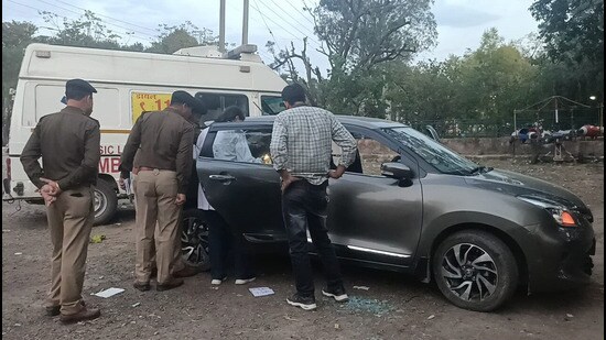Police inspecting the car in which the Chandigarh police constable was found dead in car at Mata Mansa Devi Complex, Sector 4, Panchkula, on Tuesday evening. (Sant Arora/HT)