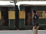 A security force personnel member stands guard near a train containing empty coffins that are dispatched to Bolan where a passenger train that was attacked by separatist militants, at a railway station in Quetta, Pakistan, March 12, 2025.