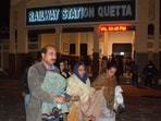 Passengers who were rescued from a train after it was attacked by separatist militants, walk with their belongings at the Railway Station in Quetta, Balochistan, Pakistan, March 12, 2025. 