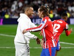 Real Madrid's Kylian Mbappe shakes hands with Atletico Madrid's Antoine Griezmann.