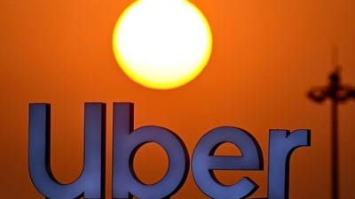 The Uber logo is pictured over their pick-up point at theKempegowda International Airport, during sunset in Bengaluru on January 4, 2025. (AFP) The Uber logo is pictured over their pick-up point at theKempegowda International Airport, during sunset in Bengaluru on January 4, 2025. (AFP)