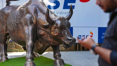 Stock market news: A man walks past the bull statue at BSE building in Mumbai. (PTI) Stock market news: A man walks past the bull statue at BSE building in Mumbai. (PTI)