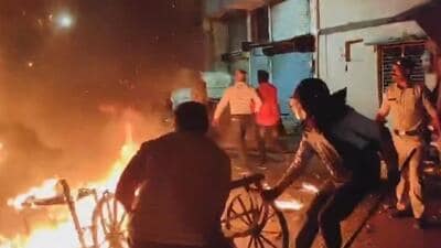 Police personnel at the site of the violence after clashes broke out in Mhow during a rally celebrating the Indian team's victory over New Zealand in the Champions Trophy final. (PTI Photo)